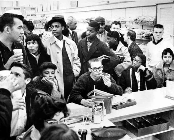Three African-American girls sit next to a white boy during a sit-in at a lunch counter in Portsmouth, Va., in February 1960. The demonstrators are largely students.