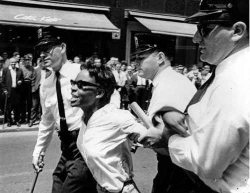 Bertha Gilbert, 22, is led away by police after she tried to enter a segregated lunch counter in Nashville, Tenn., on May 6, 1964.