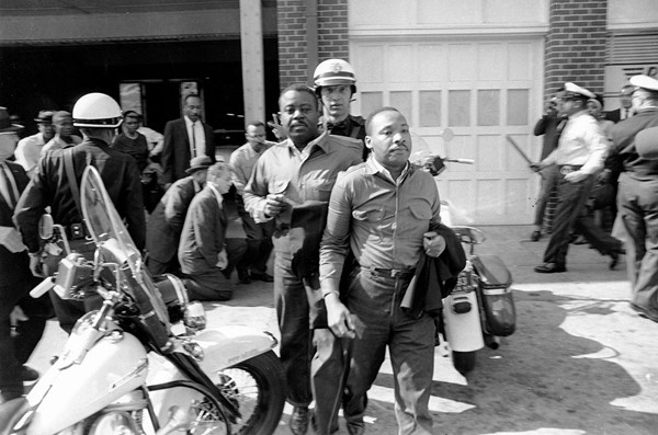 Rev. Ralph Abernathy, left, and Rev. Martin Luther King Jr., are removed by a policeman as they led a line of demonstrators into the business section of Birmingham, Alabama, on April 12, 1963.