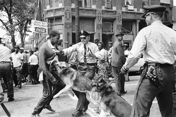 A 17-year-old civil rights demonstrator, defying an anti-parade ordinance in Birmingham, Alabama, is attacked by a police dog on May 3, 1963.