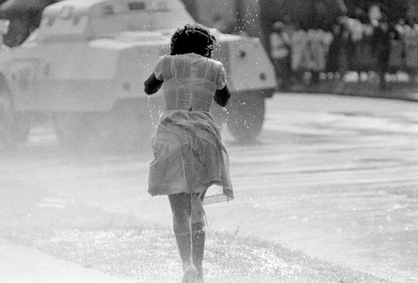 A young black woman, soaked by a fireman's hose as an anti-segregation march is broken up by police, in Birmingham, Alabama, on May 8, 1963. 