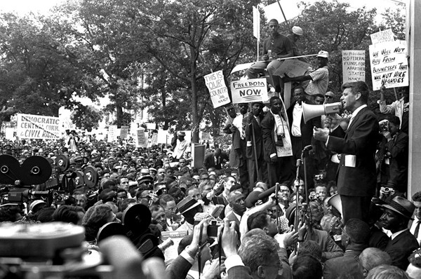 Attorney General Robert Kennedy uses a bullhorn to address black demonstrators at the Justice Department, on June 14, 1963. The demonstrators marched to the White House, then to the District Building, and wound up at the Justice Department.