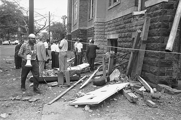 A civil defense worker and firemen walk through debris from an explosion which struck the 16th street Baptist Church, killing four girls and injuring 22 others, in Birmingham, Alabama, on September 15, 1963.